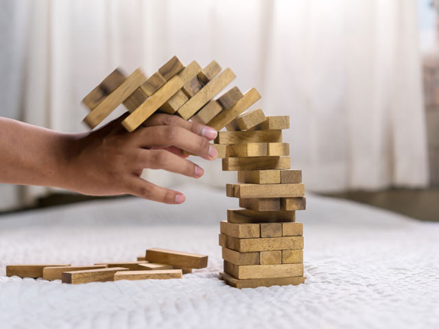 A person crashing the Drunk Jenga tower during the Beer Olympics